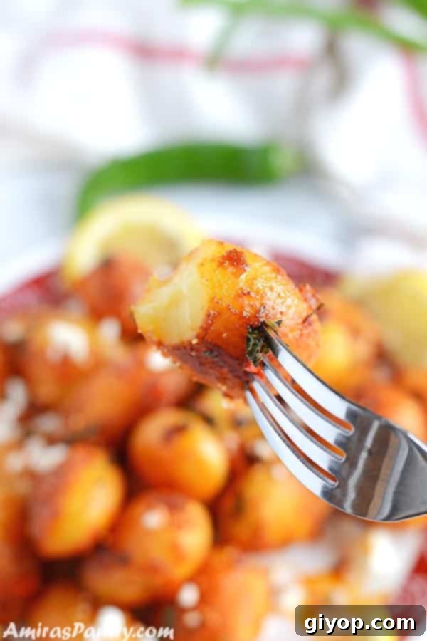 Fiery Lebanese Potatoes 6 A fork with a piece of potato with a whole plate of spicy potato salad on the back