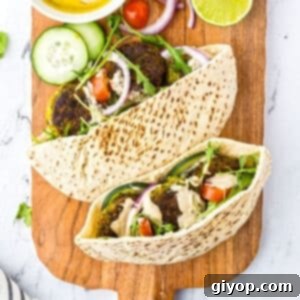 The Golden Falafel Pocket 2 An overhead view of two pitas stuffed with daladel and fresh veggies.