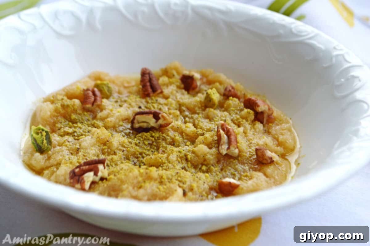 Beautifully presented wheat halva in a white bowl, adorned with finely crushed nuts, ready to be enjoyed as a traditional Middle Eastern dessert.