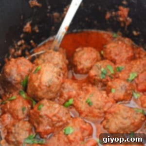 A close-up of delicious Moroccan meatballs simmering in a slow cooker, ready to be served.