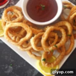 A close up of fried calamari rings on a plate