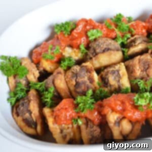 Ground beef and potato casserole on a white plate.