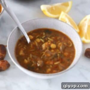 Hearty Moroccan Harira Lentil and Chickpea Soup 7 A bowl of Harira soup with a spoon in it, ready to be enjoyed.