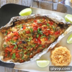 Mediterranean Baked Sea Bass 2 Cooked sea bass topped with vegetable mix.