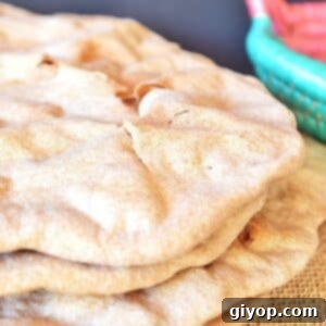 A stack of unleavened bread on a burlap surface.