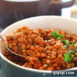 Nourishing Vegan Lentil Pot 4 A bowl filled with tender lentils and vibrant vegetables, ready to be enjoyed.