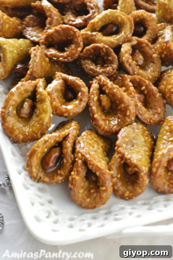 A white serving platter filled with matcha babouches drizzled in syrup