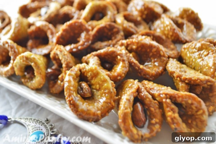 Matcha babouche cookies in a white platter with a blue good luck charm next to it.