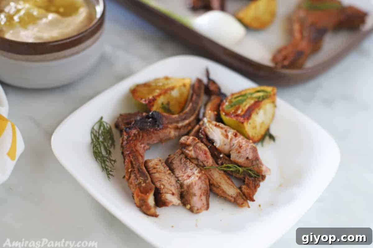 slices of lamb chops on a white plate with lemon wedges on the side.