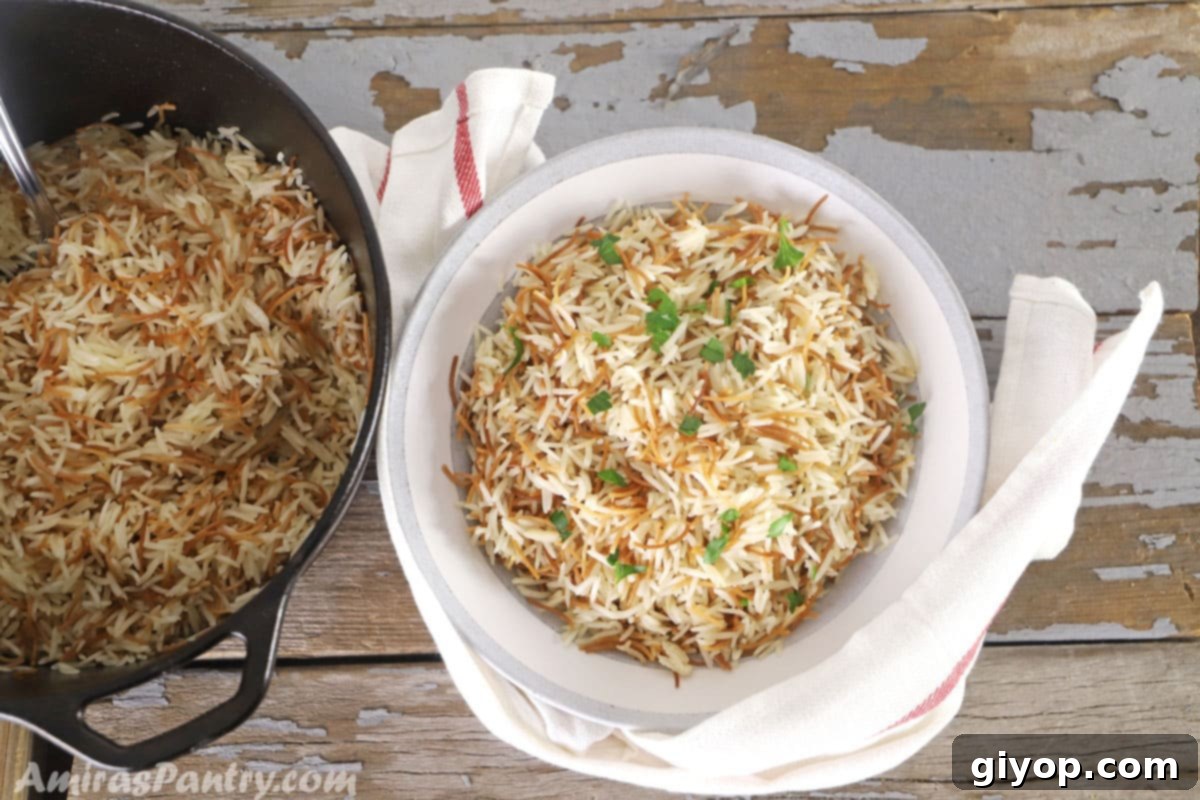 A pot of Lebanese rice with another bowl of rice on a wooden table, emphasizing its role as a simple vermicelli rice staple side dish.