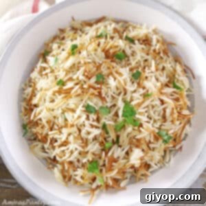 Lebanese rice in a grey bowl garnished with parsley