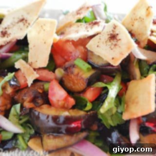 Effortless Eggplant Salad 6 Eggplant salad on a white dish, showcasing the final presentation.