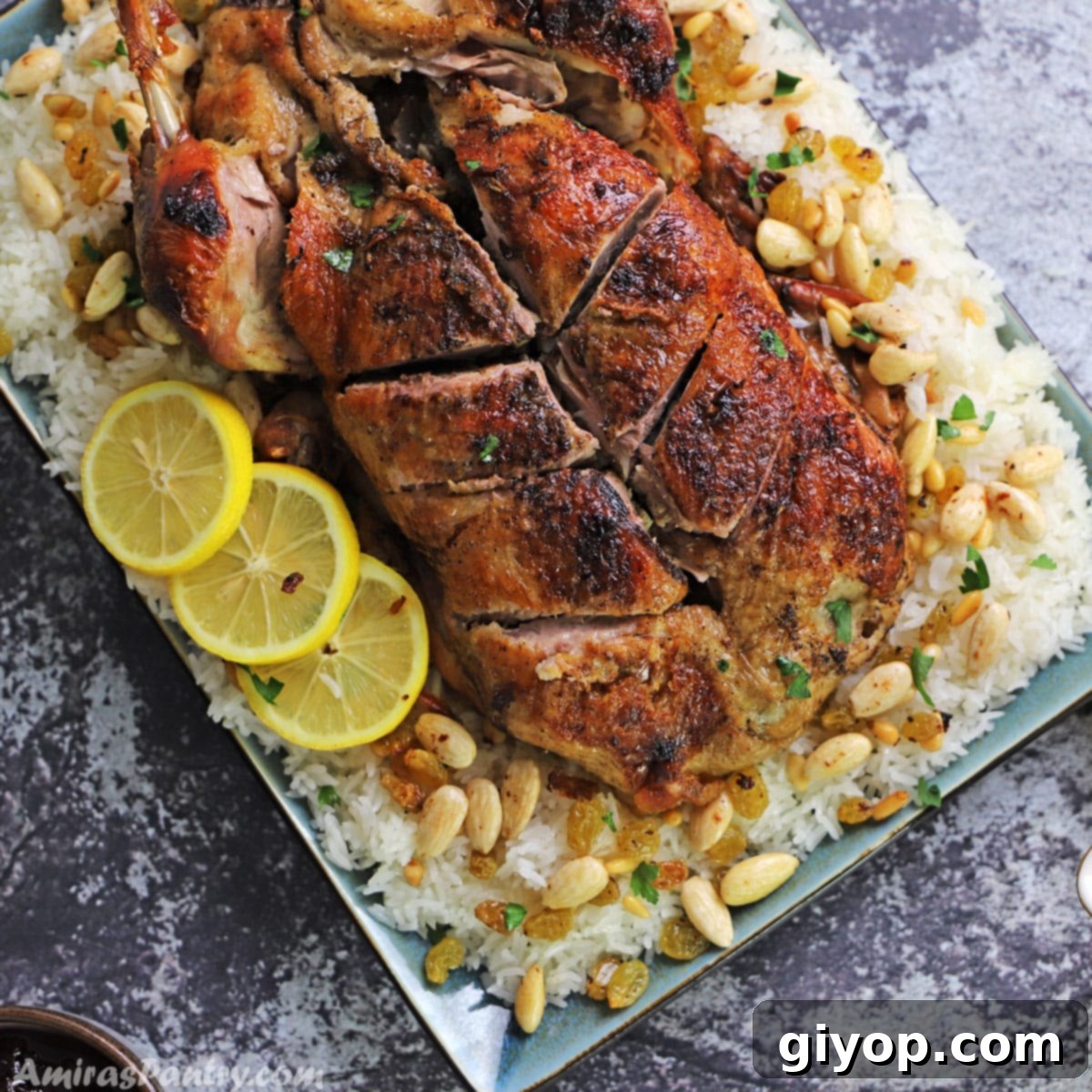 A beautifully roasted whole duck, golden and crispy, resting on a bed of flavorful rice, garnished with toasted nuts. This is a traditional Middle Eastern stuffed duck recipe.