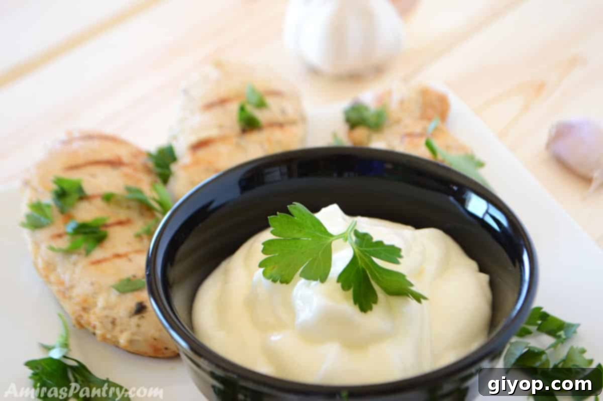 Authentic Lebanese Toum Garlic Sauce Recipe 3 Garlic dip in a bowl with grilled chicken.