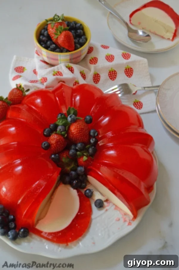A plate featuring a slice of colorful Jello and cream cheese bundt cake, highlighting its unique texture.
