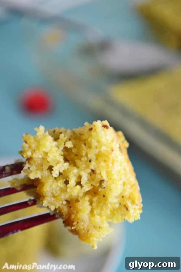 A close-up shot revealing the intricate texture and rich green color of a pistachio semolina cake, highlighting the generous amount of pistachios within.