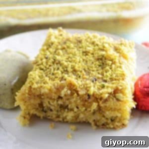 A piece of cake on a plate, with Pistachio