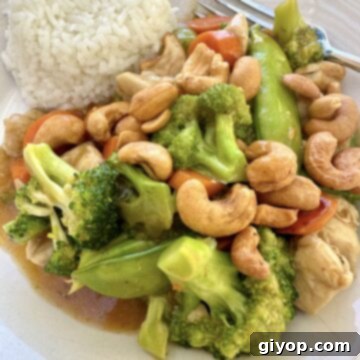 A serving of cashew chicken stir fry with rice.