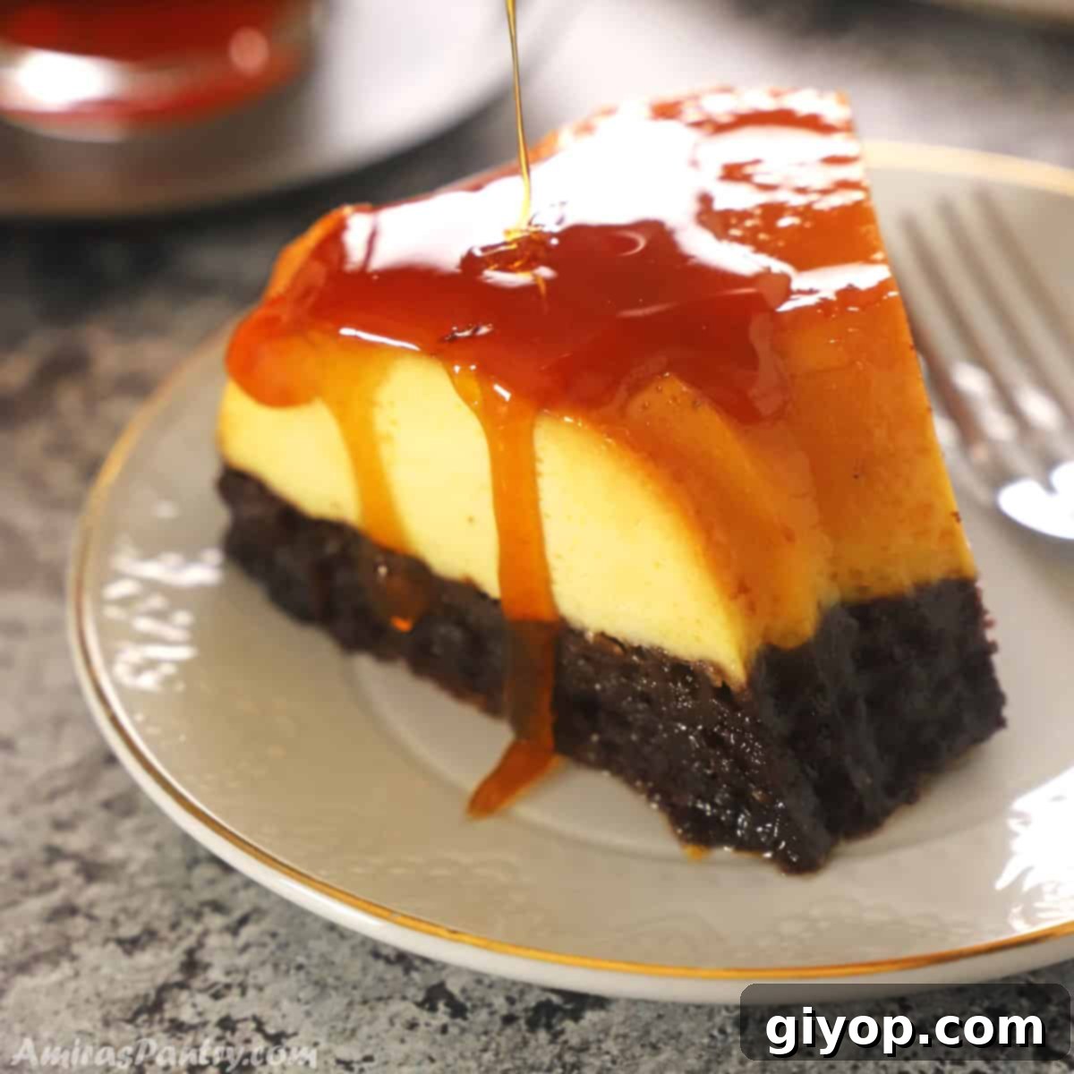 Impossible Chocolate Flan 2 A piece of chocoflan on a white dessert plate with caramel dropping down its side.