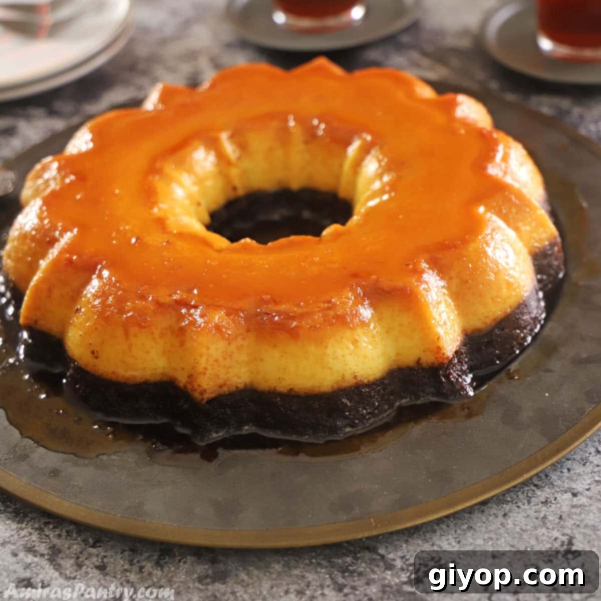 Impossible Chocolate Flan 7 Chocoflan inverted on a metal platter and placed on a dark countertop.