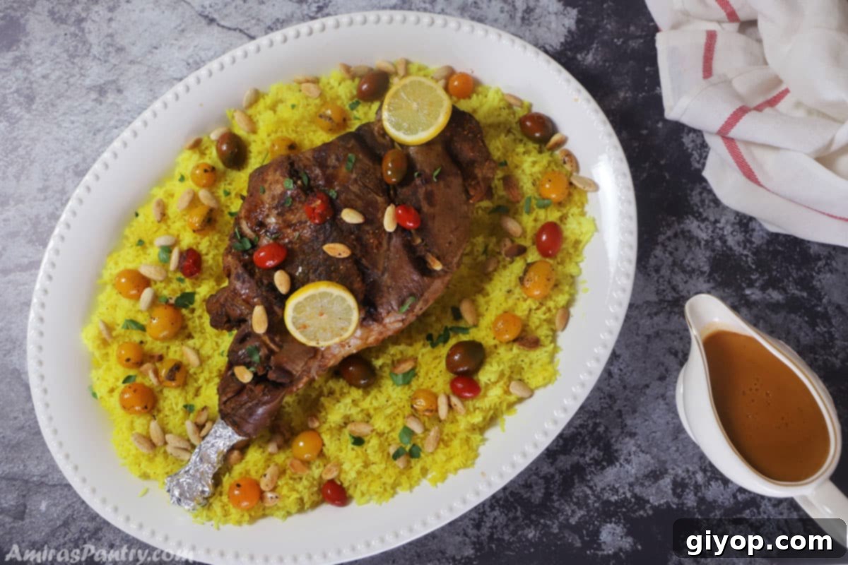 Spiced Middle Eastern Lamb Leg 5 A large white serving platter presenting a beautifully roasted leg of lamb alongside a bed of yellow rice, garnished with roasted nuts and fresh herbs.