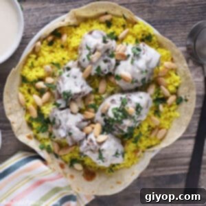 Mansaf platter placed on a wooden table.