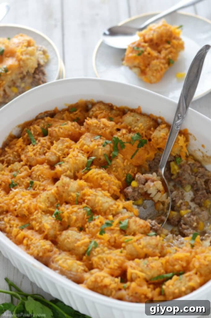 5-Day Meal Plan 5 A white casserole of tater tot with a spoon in it.