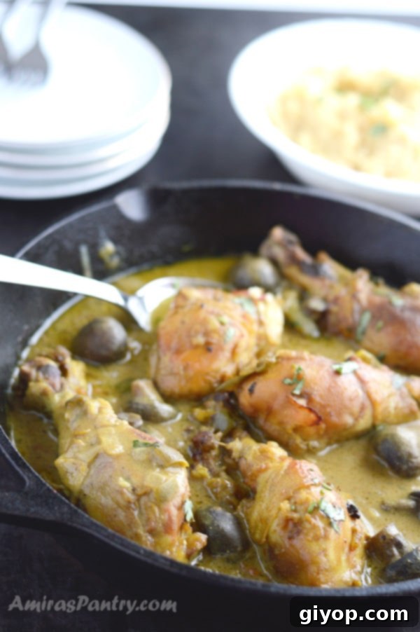 A bowl of tahini chicken stew, rich in color and texture, topped with fresh parsley.