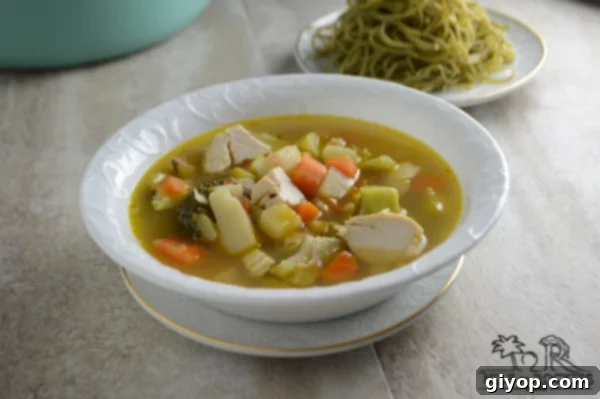 Friday's Leftover Comfort 4 A vibrant bowl of homemade soup, showcasing a mix of vegetables and chicken, ready to be enjoyed.