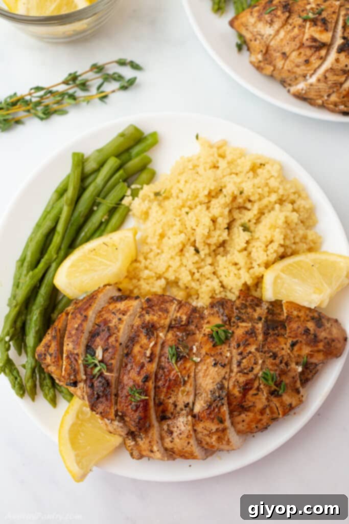 Succulent oregano chicken pieces, garnished with fresh herbs and a lemon wedge, ready to be served as a healthy and quick dinner.