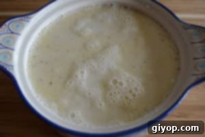 A bowl of rice and milk on a table