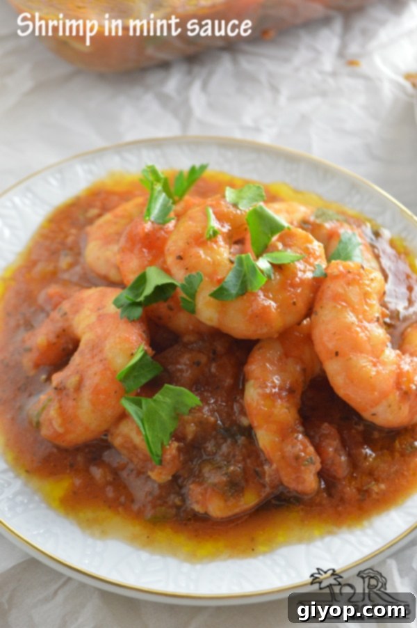 A close-up of a bowl filled with succulent shrimp stew, rich in a vibrant, savory sauce, garnished with fresh herbs.