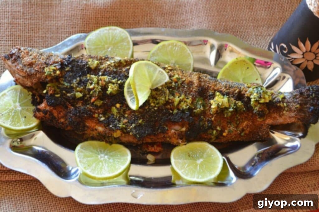 Effortless Meal Planning 5 A perfectly grilled whole trout resting on a silver serving platter, garnished with fresh lemon slices.