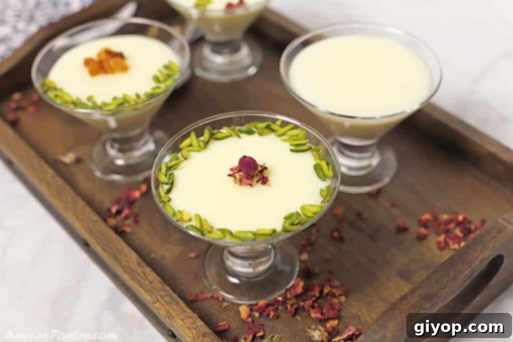 Effortless Meal Planning 7 Four elegant glass cups of creamy milk pudding, garnished and placed on a dark brown wooden tray.