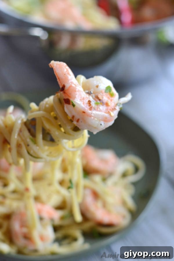 Close-up of a bowl of Shrimp Scampi pasta, featuring succulent shrimp tossed in a rich sauce with linguine.