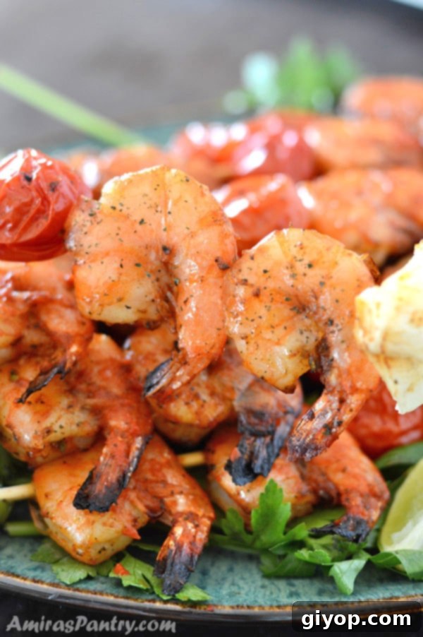 Flavorful grilled shrimp kabobs on skewers, artfully arranged on a plate, ideal for a quick and easy mid-week meal.
