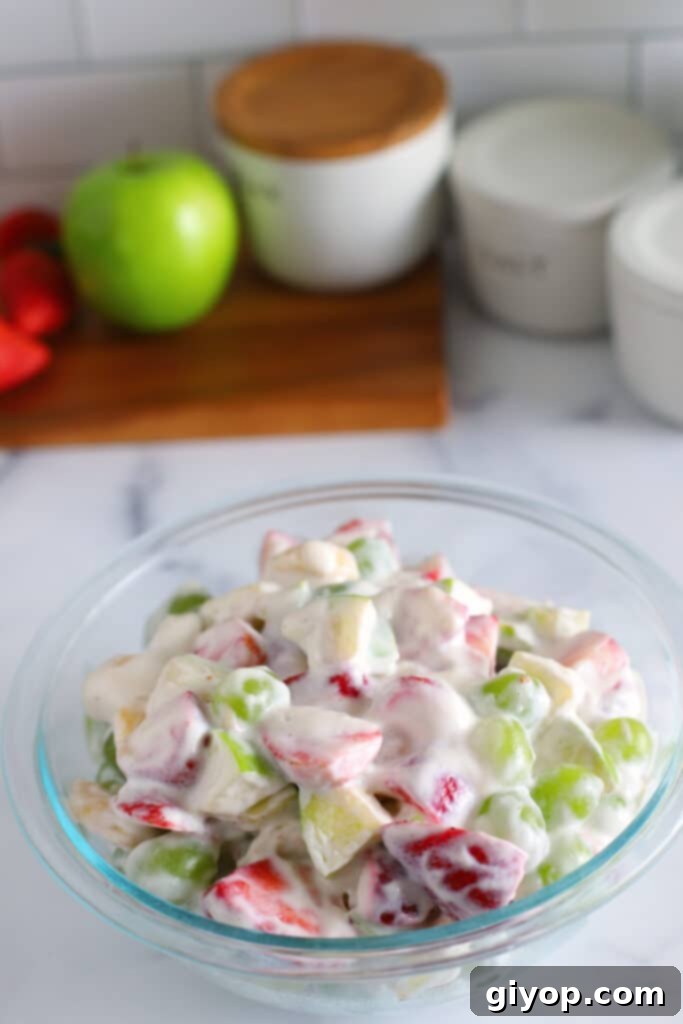 34 Diverse Meal Plans 7 A beautifully presented creamy fruit salad in an elegant glass bowl, showcasing a vibrant mix of fresh, colorful fruits.