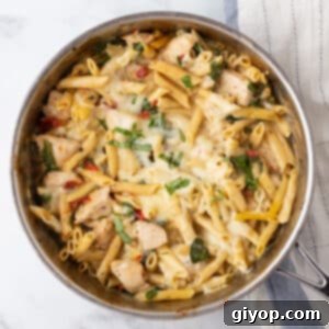 A top view of a skillet with creamy tuscan chicken pasta.