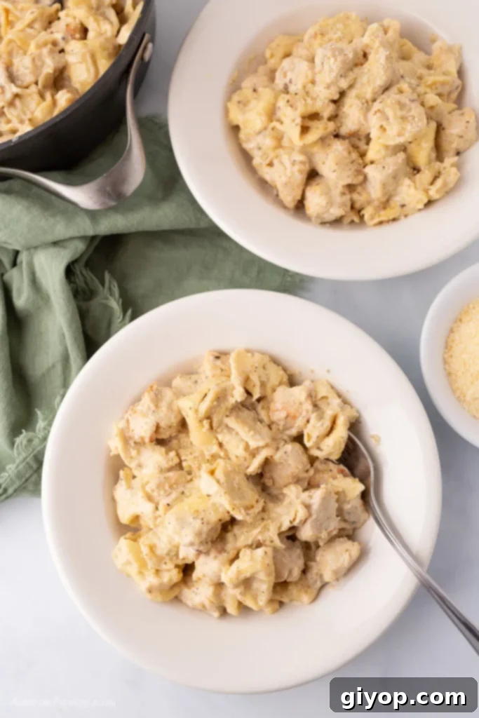 46 Smart Meal Solutions 3 A comforting bowl of Chicken Tortellini Alfredo, featuring tender tortellini and chicken in a rich, creamy Alfredo sauce, garnished with fresh parsley.