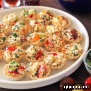 Stuffed phyllo cups appetizer on a white seving platter.