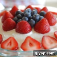 A beautifully presented no-bake berry dessert with a golden Oreo crust and fresh fruit topping.