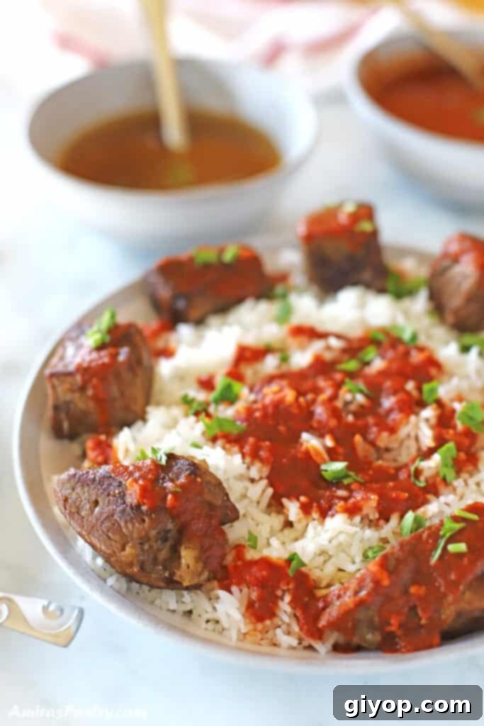 A grand platter of traditional Egyptian Fattah displayed on a white marble table, ready to be enjoyed.