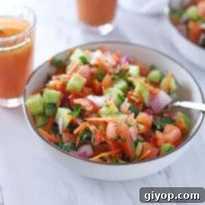Egyptian Baladi Salad 2 Salad in a bowl with a spoon and cups of marinade on the back.