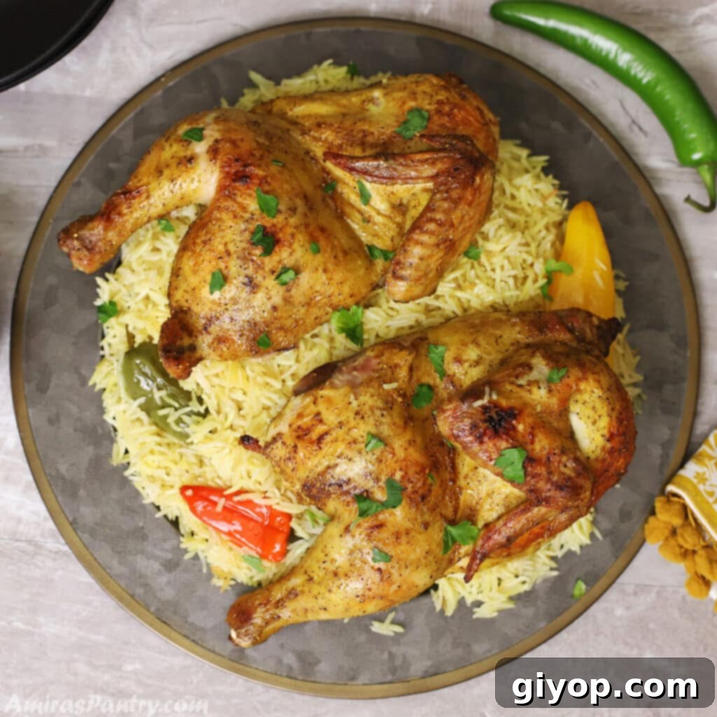 A big serving platter of Chicken Mandi, featuring aromatic rice and fork-tender chicken, garnished with chopped parsley.