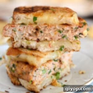 Italian sausage sandwich on a white plate.