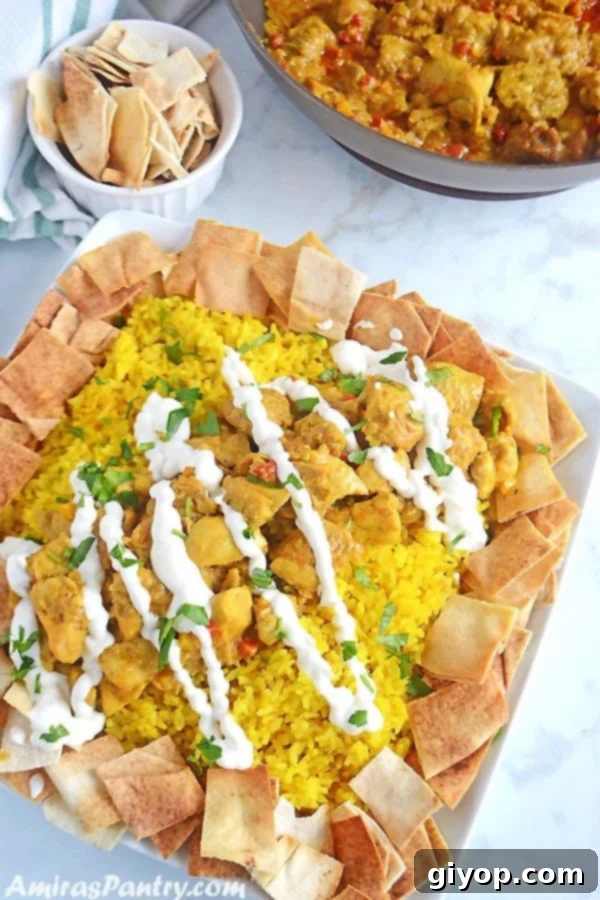 Meal Plan 3 A white square platter generously piled with golden yellow rice and tender chicken shawarma, artfully arranged with toasted pita bread on the side.