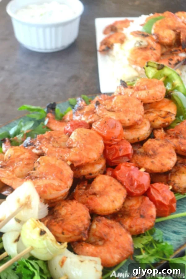 Meal Plan 4 A vibrant plate overflowing with perfectly grilled shrimp kabobs, skewered and ready to enjoy, with another full skewer visible in the background.