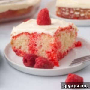 A slice of jello poke cake on a white dessert plate.