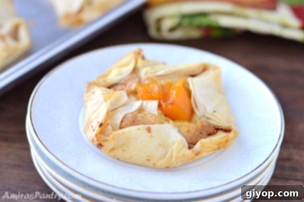 Another enticing view of an eggless pumpkin frangipane tart, beautifully presented on stacked white plates, highlighting the exquisite details of the pastry.