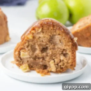 A beautifully presented slice of apple bundt cake, revealing its moist texture.